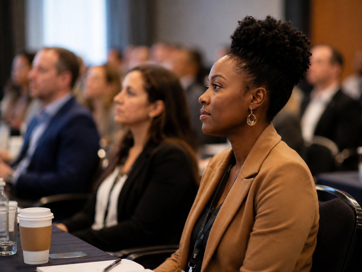 Professionals listen during a conference workshop session